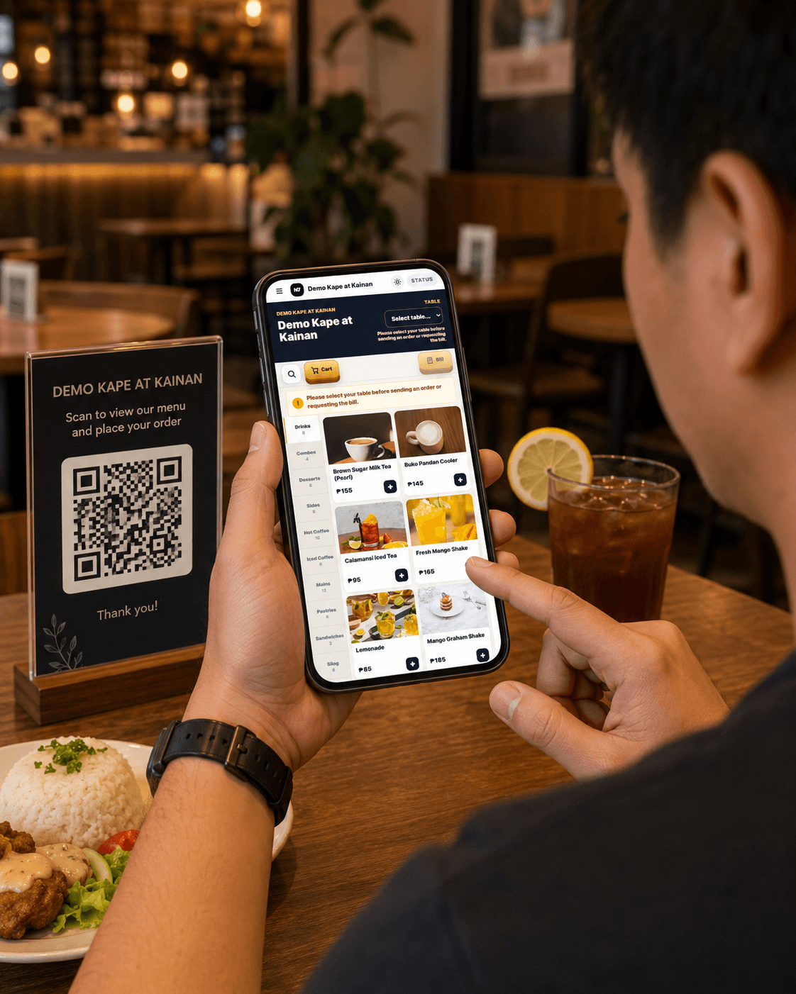 Customer scanning a QR code at a café table to browse the menu and order from their phone